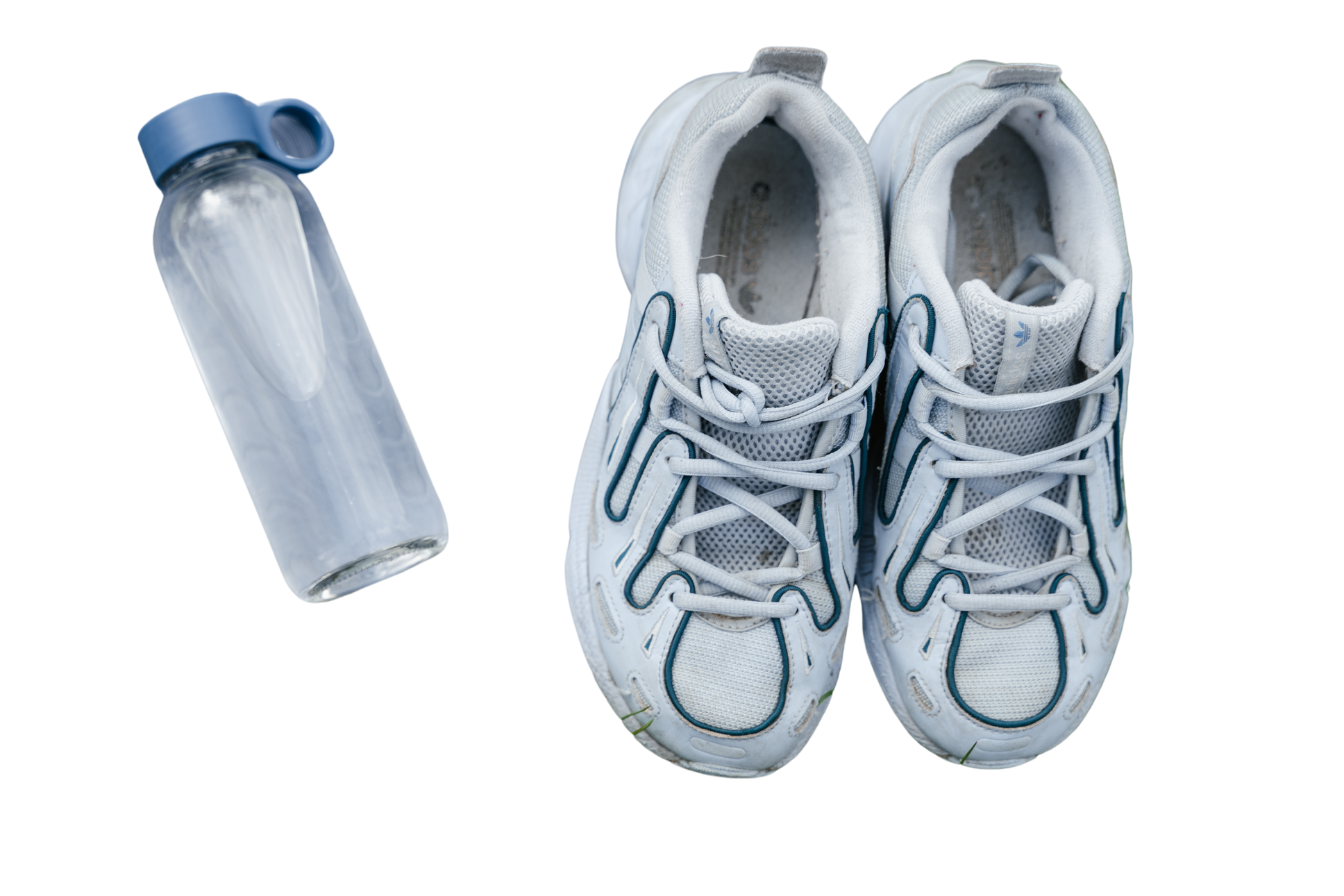 White and Blue Running Shoes on Gray Yoga Mat